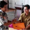 Sekretaris KPU Kuningan saat menyerahkan piagam penghargaan kepada PPK yang partisipasi masyarakatnya pada pileg tinggi.